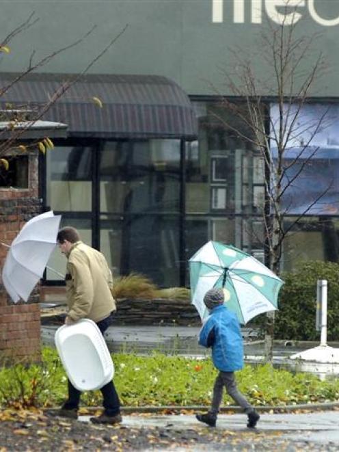Wet and windy weather did not deter these Dunedin shoppers yesterday. Photo by Gregor Richardson.