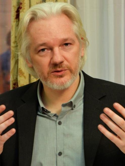 WikiLeaks founder Julian Assange gestures during a news conference at the Ecuadorian embassy in...