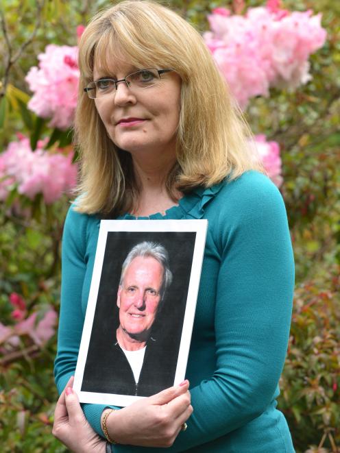 Debbie Williamson, of Dunedin, holds a picture of her late husband, Brendon Garden, who died from...