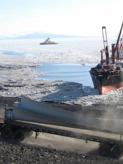 Wind turbine blades are transported by truck from McMurdo Station ice pier to the site where the...