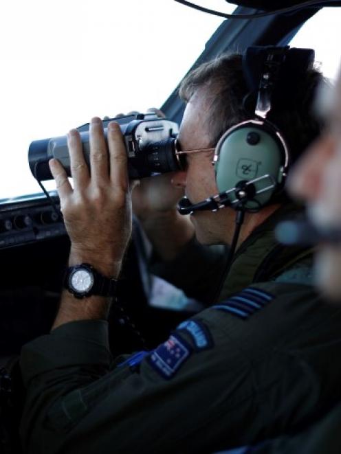 Wing Commander Rob Shearer looks out from the flight deck of a Royal New Zealand Air Force P-3K2...