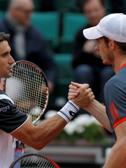 Winner David Ferrer of Spain (L) shakes hands with Andy Murray of Britain after their...