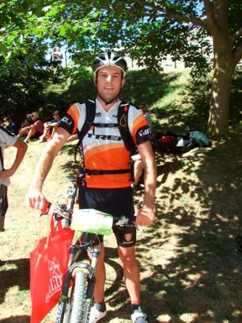 Winner of the elite men's mountain bike category, Dirk Peters, at the finish line after setting a...