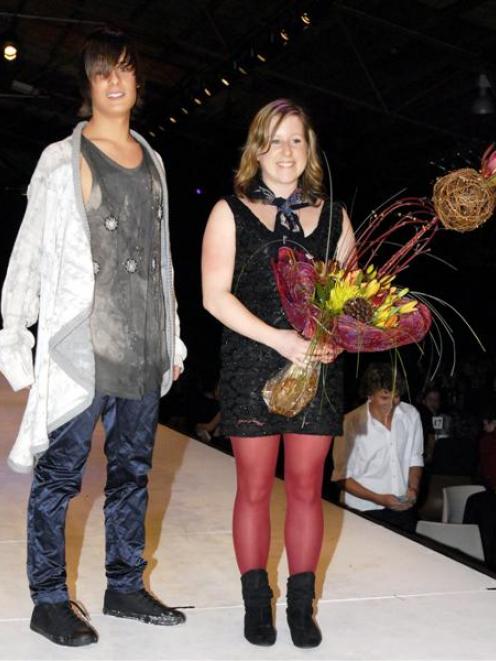 Winner of The Ensign Award of Excellence Laura Marshall, of Dunedin, standing beside a model...