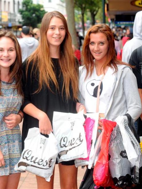 With bags full of clothes bought from Boxing Day sales, Dunedin teenagers (from left) Emma...