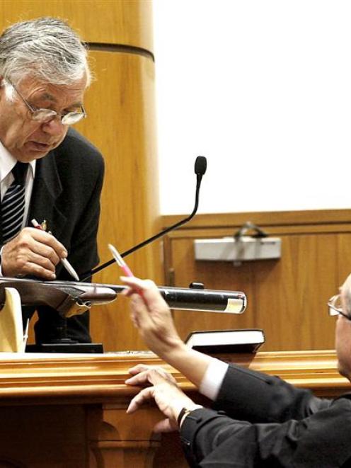 Witness Peter Hentschel (left) and defence counsel Michael Reed QC point to the murder weapon.