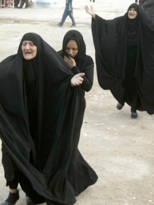 Women mourn during a funeral of a victim who was killed in a bomb attack in Baghdad. REUTERS/Ali...