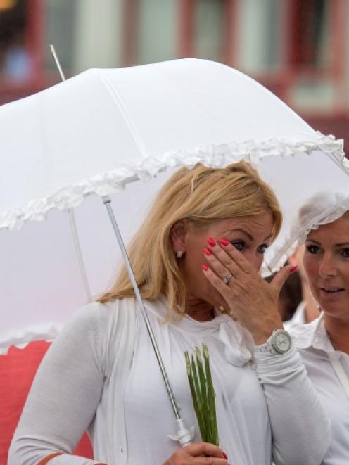 Women participate in a silent march in Rotterdam to pay their respects to Jenny Loh and Popo Fan,...