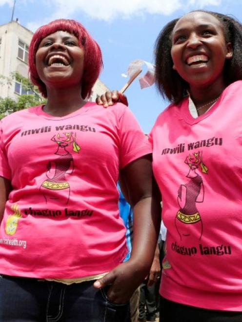 Women take part in a protest in Nairobi demanding justice for a woman who was attacked and...