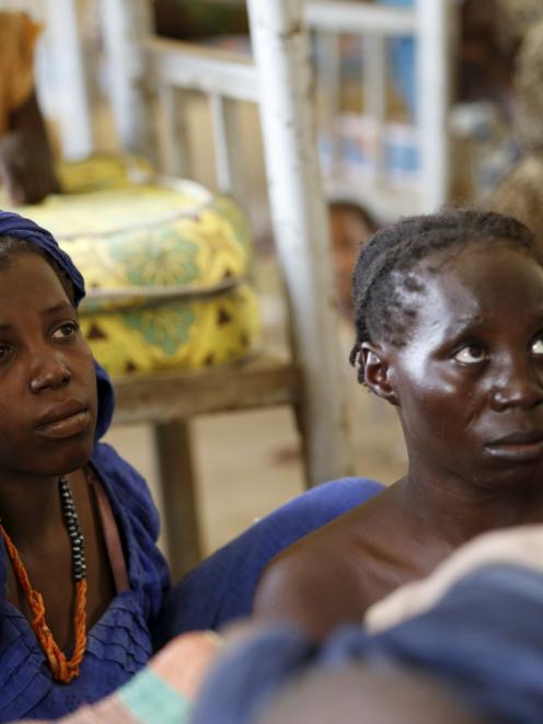 Women, who were freed by the Nigerian army from Boko Haram militants in the Sambisa forest, looks...
