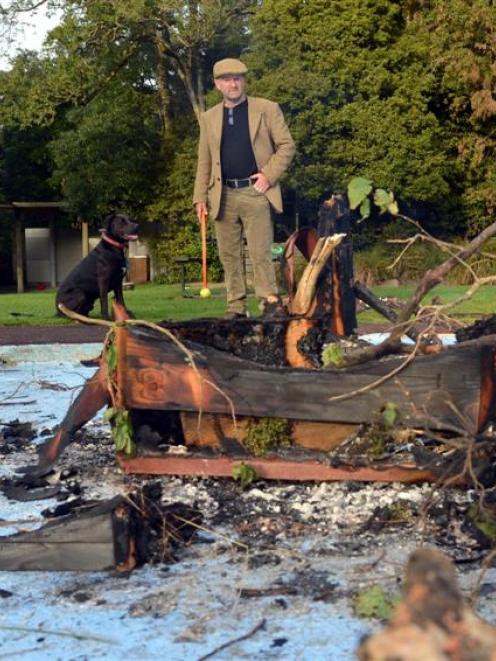 Woodhaugh resident Jeff Dickie inspects the damage to the toddler's pool after a party yesterday....