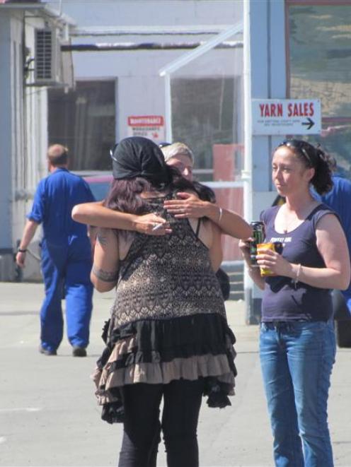 Workers console each other. Photos by Andrew Ashton.