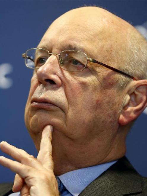World Economic Forum executive chairman and founder Klaus Schwab pauses during a news conference...
