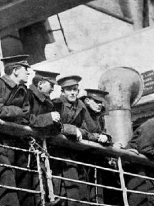 Wounded and invalided soldiers ranged along the rail of the Warrimoo, scanning the crowd at...
