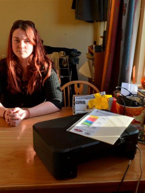 Writer Marnie Walters sits in the Dunedin villa yesterday where a window was forced open and '...