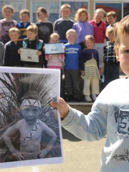 Wyatt Scholten (5) holds a photograph of himself which was first equal in the New Zealand Best...