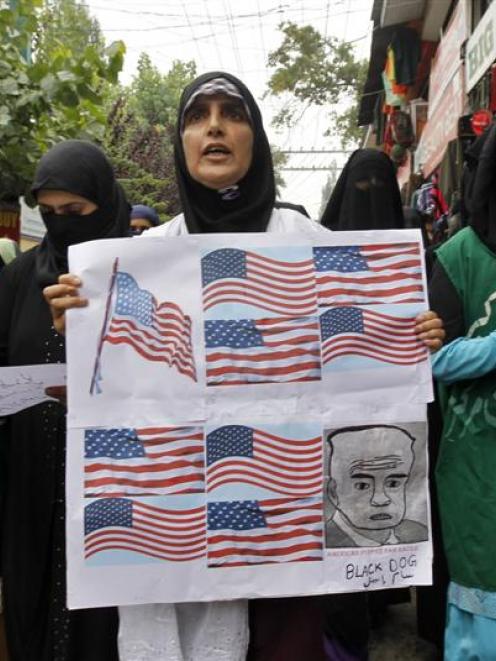 Yasmeen Raja (C), the leader of Muslim Khawateen Markaz, a Kashmiri women's separatist group,...