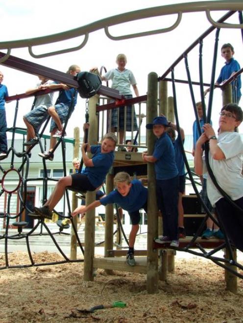 Years 6, 7 and 8 pupils test out the new playground at Balclutha Primary School yesterday. Photo...