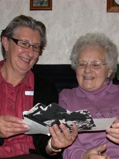 Yvonne Plant (left) and Audrey Couper enjoy looking at old photographs as they reminisce about...