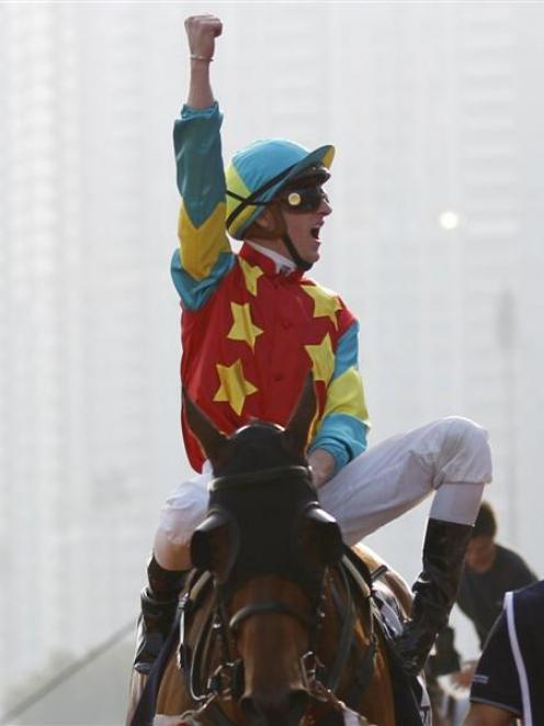 Zac Purton  cheers after winning the Hong Kong Mile on Ambitious Dragon at Sha Tin on Sunday....