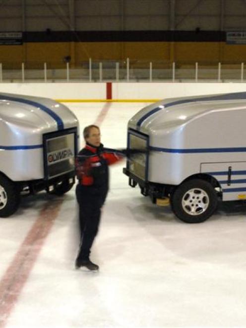 Dunedin ice skating coach Fanis Shakirzianau has a spin in front of the two resurfacing machines...