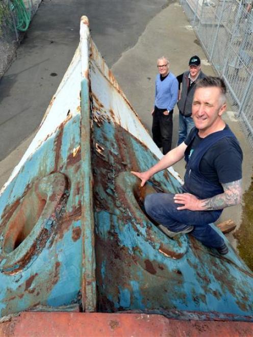 Zeal Steel owner Lawrie Forbes and sculptors Peter Nicholls and Stephen Mulqueen examine the bow...