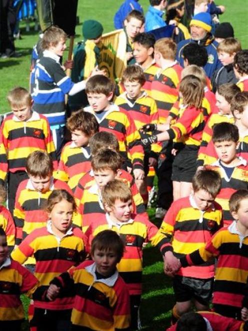 Zingari players take part in a junior march past at Carisbrook last month. Photo by Craig Baxter.
