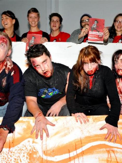 Zombies (from left) Andrew Moar, Corey Haley, Abigail Pigden and Jemima Pigden emerge from a...