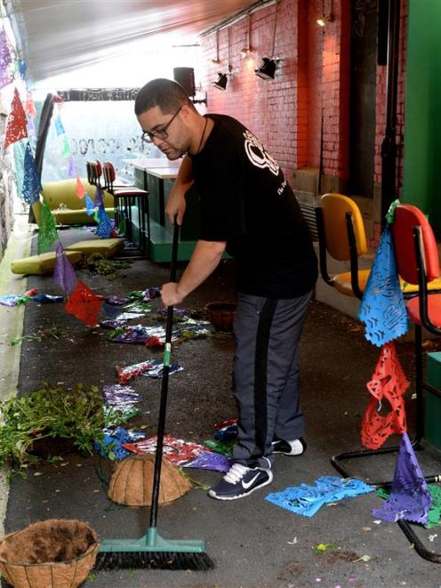 Alley Cantina manager and head chef Lenin Matahaere cleans up a mess left by vandals early...