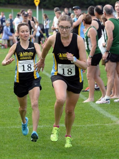 Hill City-University runner Shireen Crumpton (left) tags team-mate Bella Bloomfield during  the...