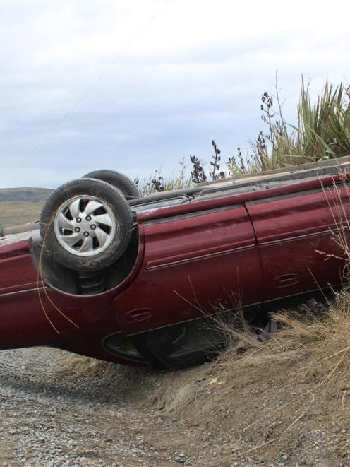 The occupants of this Toyota Avalon  freed  themselves from the overturned vehicle after it...