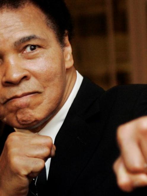 Muhammad Ali poses during the Crystal Award ceremony at the World Economic Forum in Davos,...