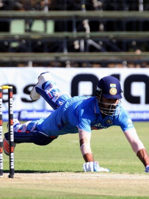 India's Lokesh Rahul dives to avoid being run out. Photo Reuters