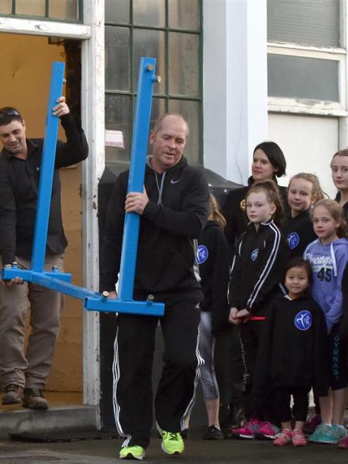 Barry Stevens (front) and Tony McLellan move gym equipment from the Dunedin Gymnastics Academy...