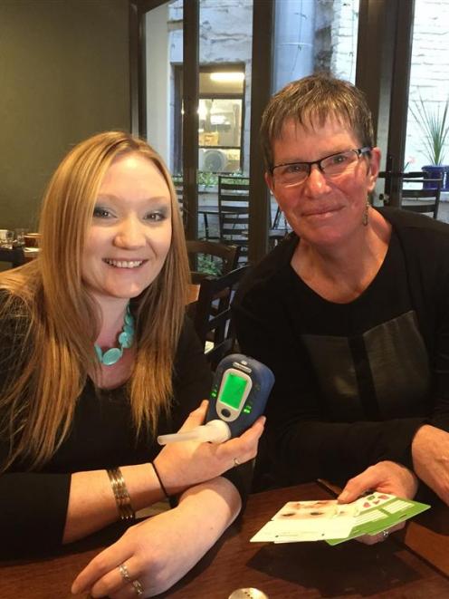 Corinna Campbell (left) displays the device used to test her breath for carbon monoxide as SDHB...