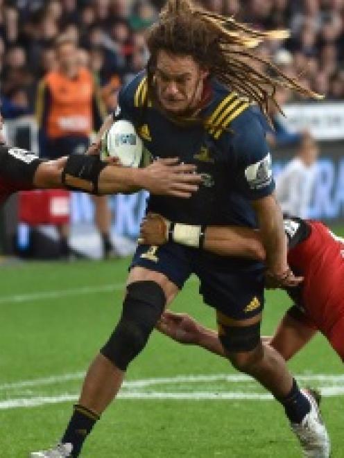 Highlanders loose forward Dan Pryor is caught by the Crusaders defence during their match in...