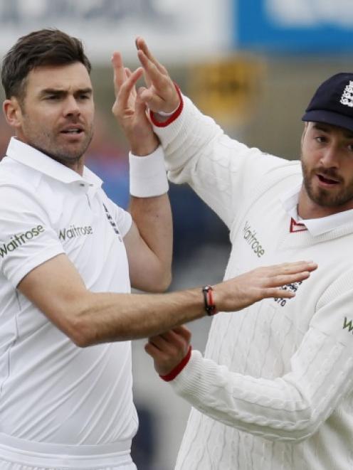 James Anderson celebrates taking a wicket with James Vince. Photo: Reuters