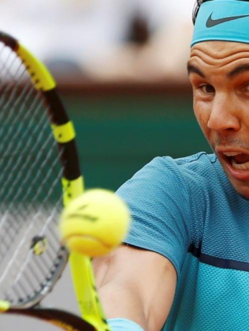 Rafael Nadal returns the ball to Facundo Bagnis. Photo Reuters
