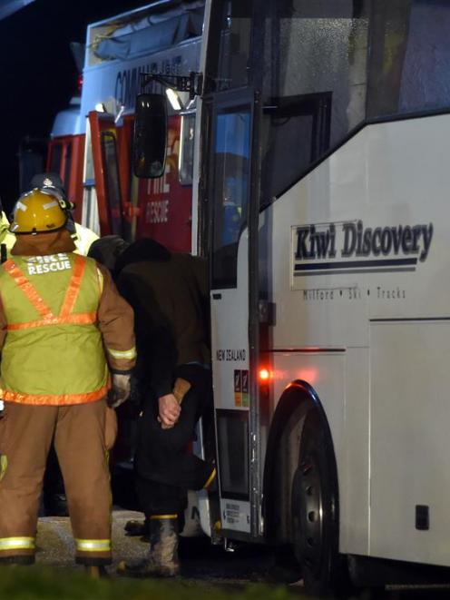 Some of the group are escorted from the bus that delivered them to the Roxburgh Rugby Club after...