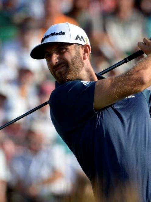 Dustin Johnson hits his tee shot on the 12th hole during the final round. Photo: Michael Madrid...