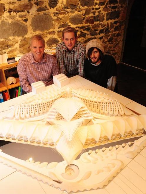 Fred van Brandenburg (left), son Damien (middle) and employee Griff Humphrey examine the model of...
