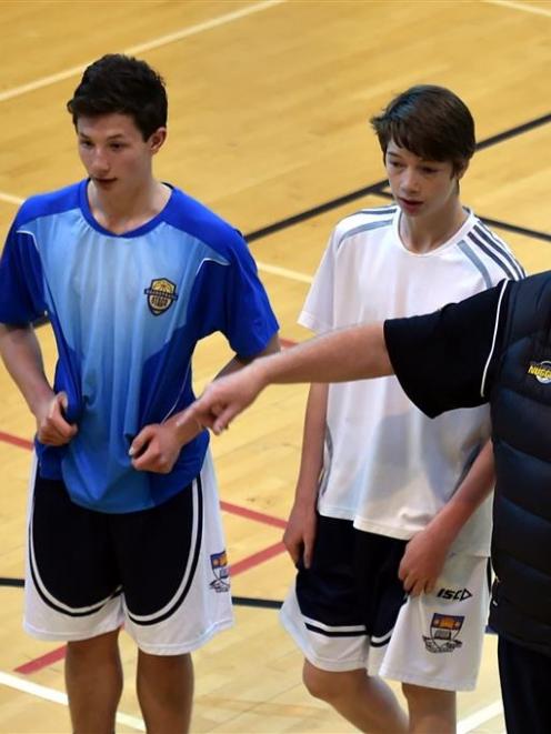 Junior Tall Blacks assistant coach Gavin Briggs gives Tyler Summers (15, left) and Sam Alder (15)...