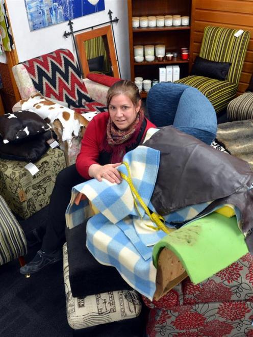 Rebecca Bungard works on a child’s armchair at Chairful Upholstery Studio in Clinton. PHOTO:...