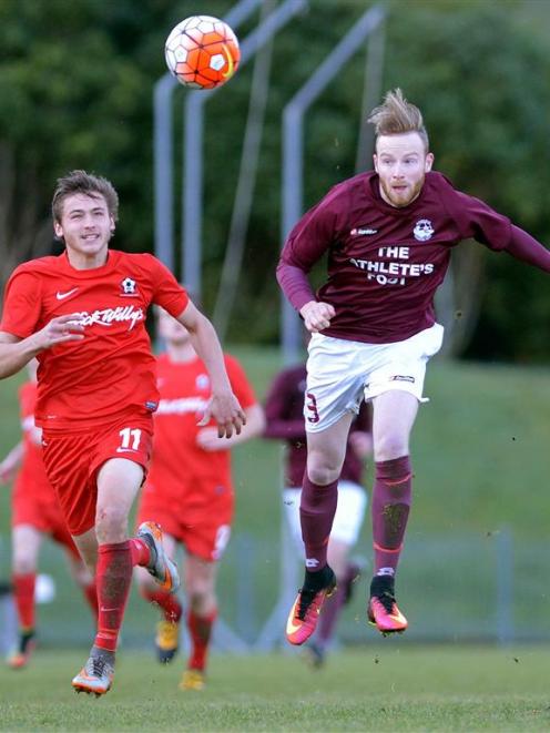 Ross Howard, of Dunedin Technical, heads the ball while Caversham’s Lewis Jackson looks on at the...