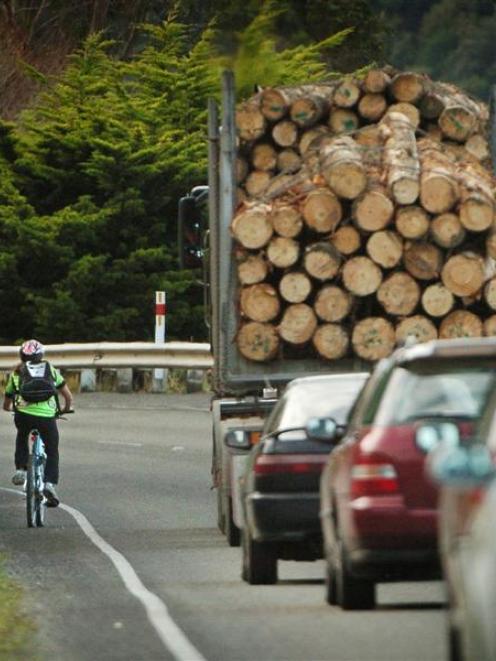 Traffic passes a cyclist on State Highway 88 near Blanket Bay. Photo ODT files