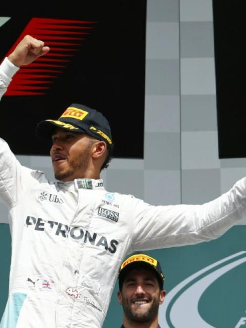 Lewis Hamilton celebrates after winning the race. Photo: Reuters