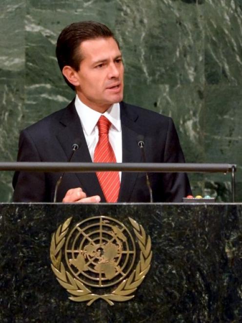 Mexican President Enrique Pena Nieto addresses the audience during a special session on global...