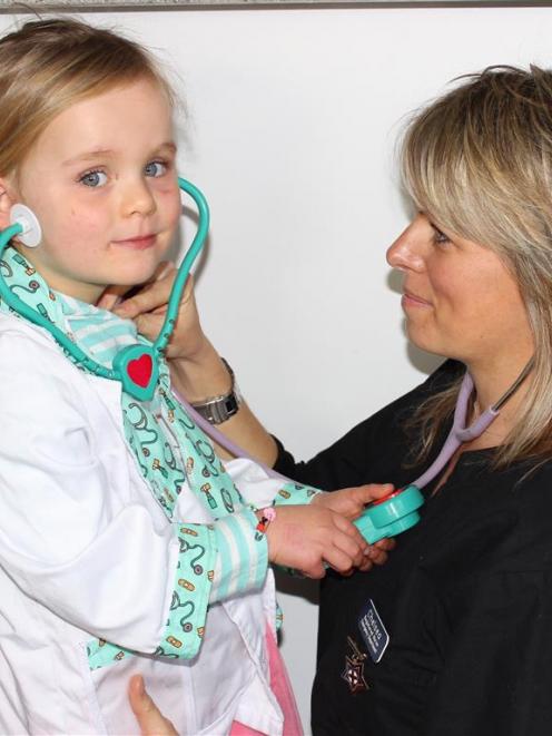 Nurse Chelsea Willmott and daughter Ella (3) give each other check-ups at their Wanaka home...