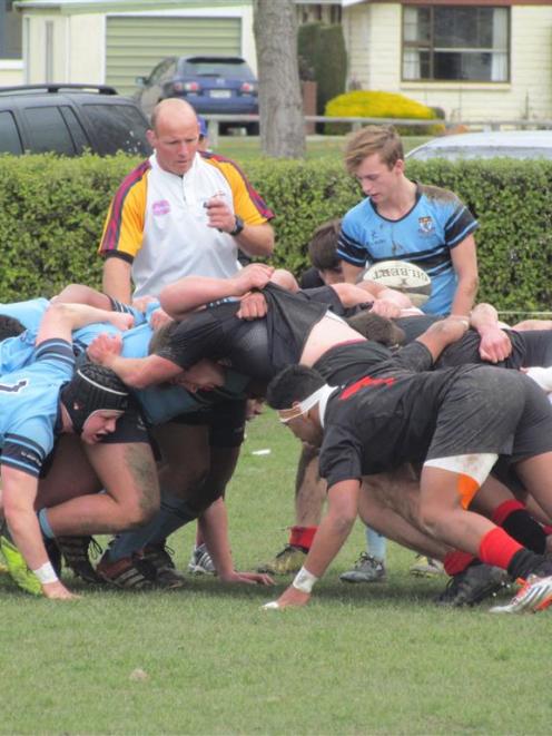 Referee Nick Webster stands by as a scrum is set during the Otago First XV semifinal between...