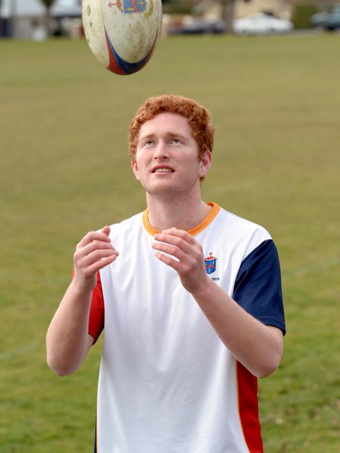 John McGlashan College First XV lock Sam Moir-Grace tosses the ball around before a training...